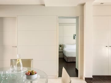 a room with a glass table and chairs.