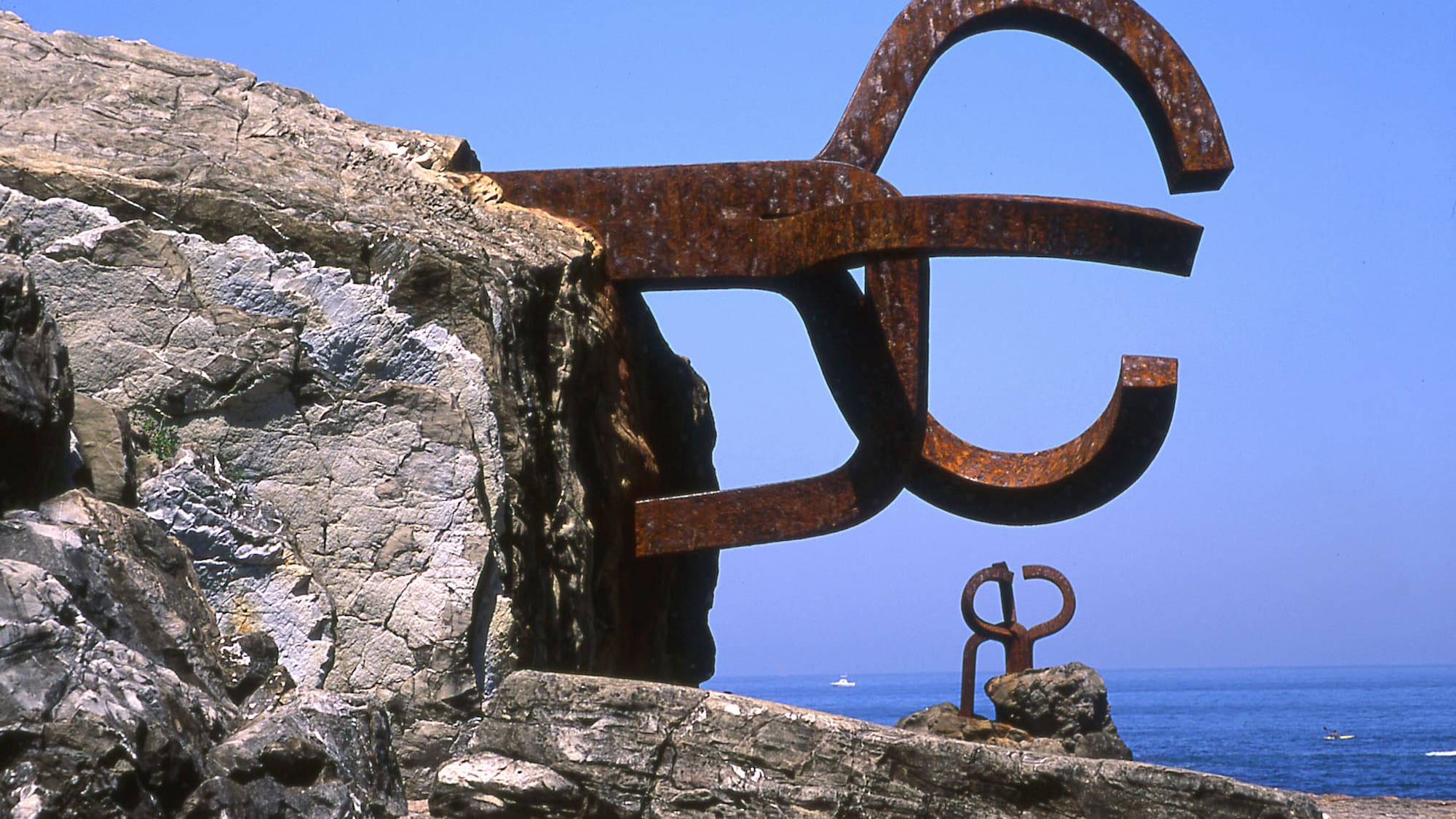 a large metal sculpture on a rock