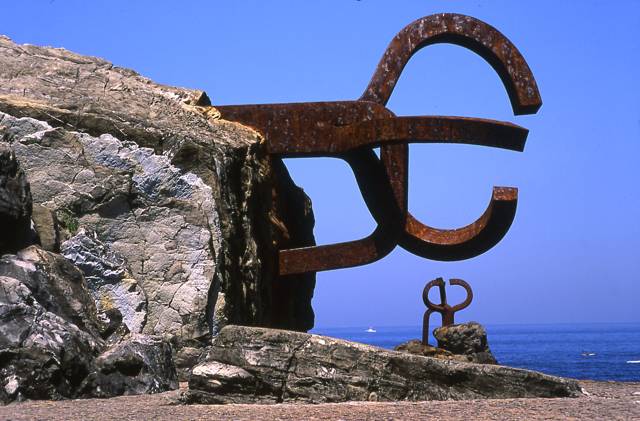 a large metal sculpture on a rock