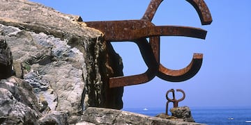 a large metal sculpture on a rock