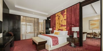 a room with a bed and red carpet