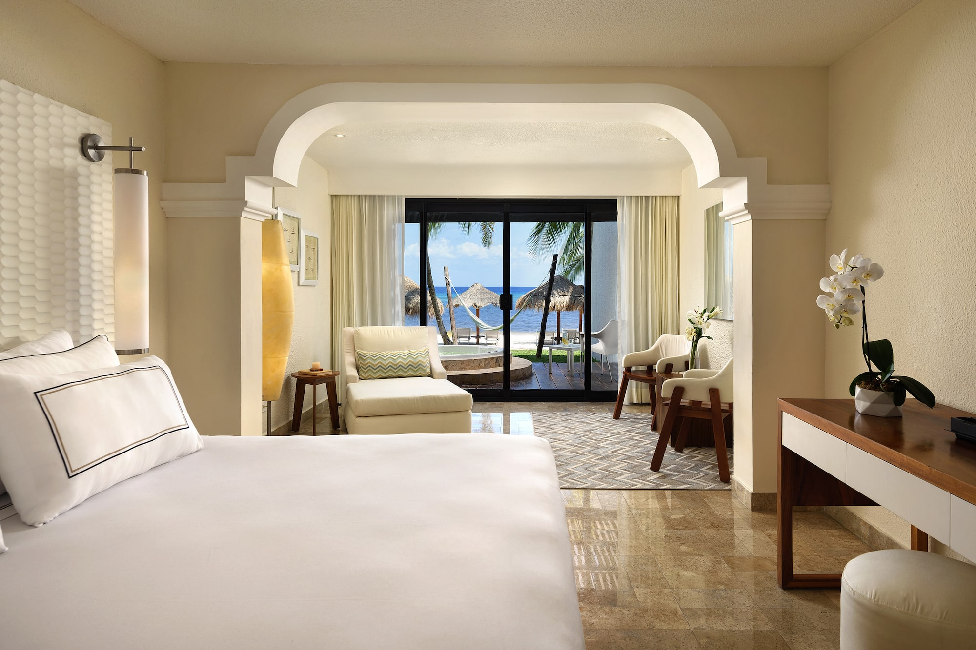 a room with a bed and chairs and a table