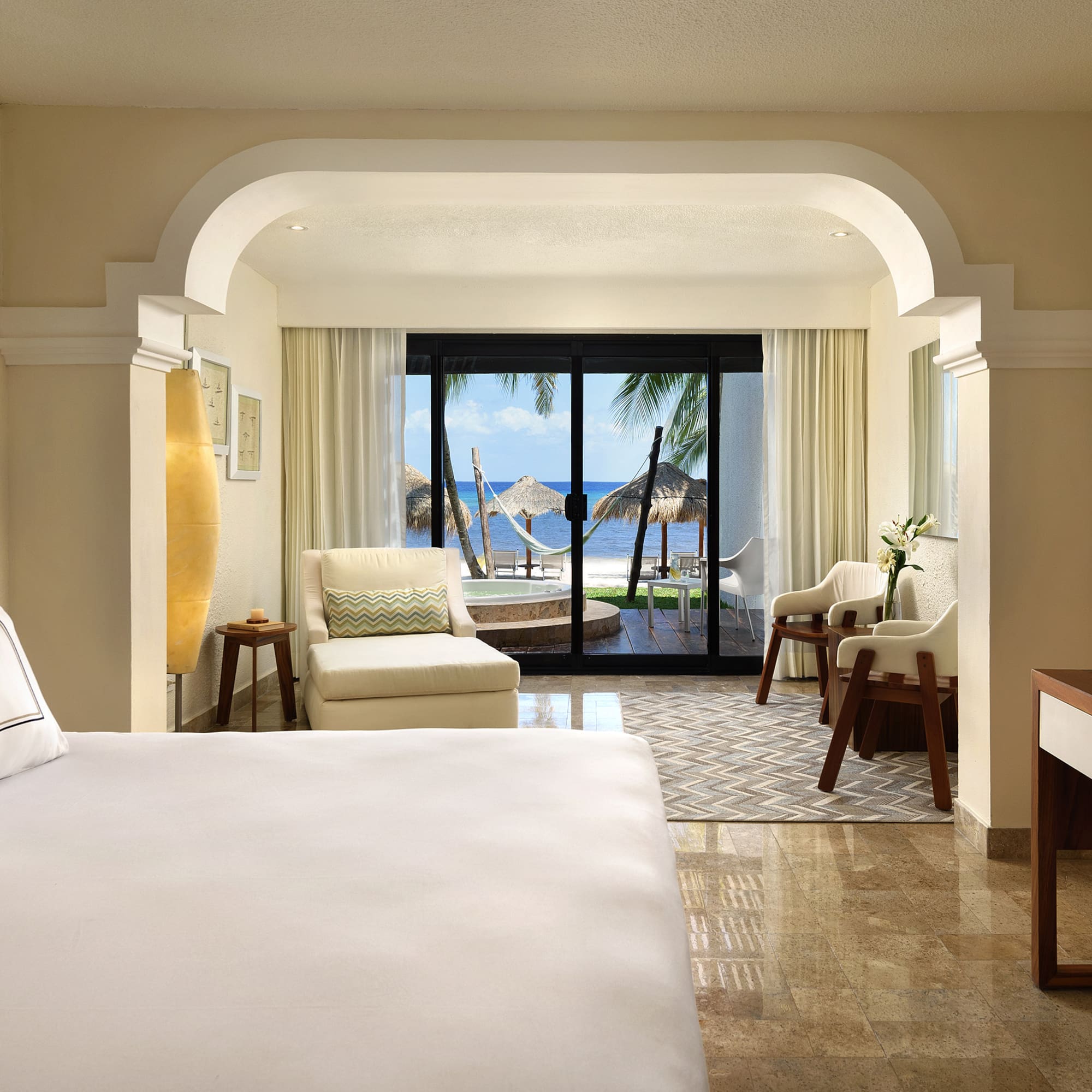 a room with a bed and chairs and a table