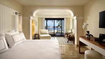 a room with a bed and chairs and a table