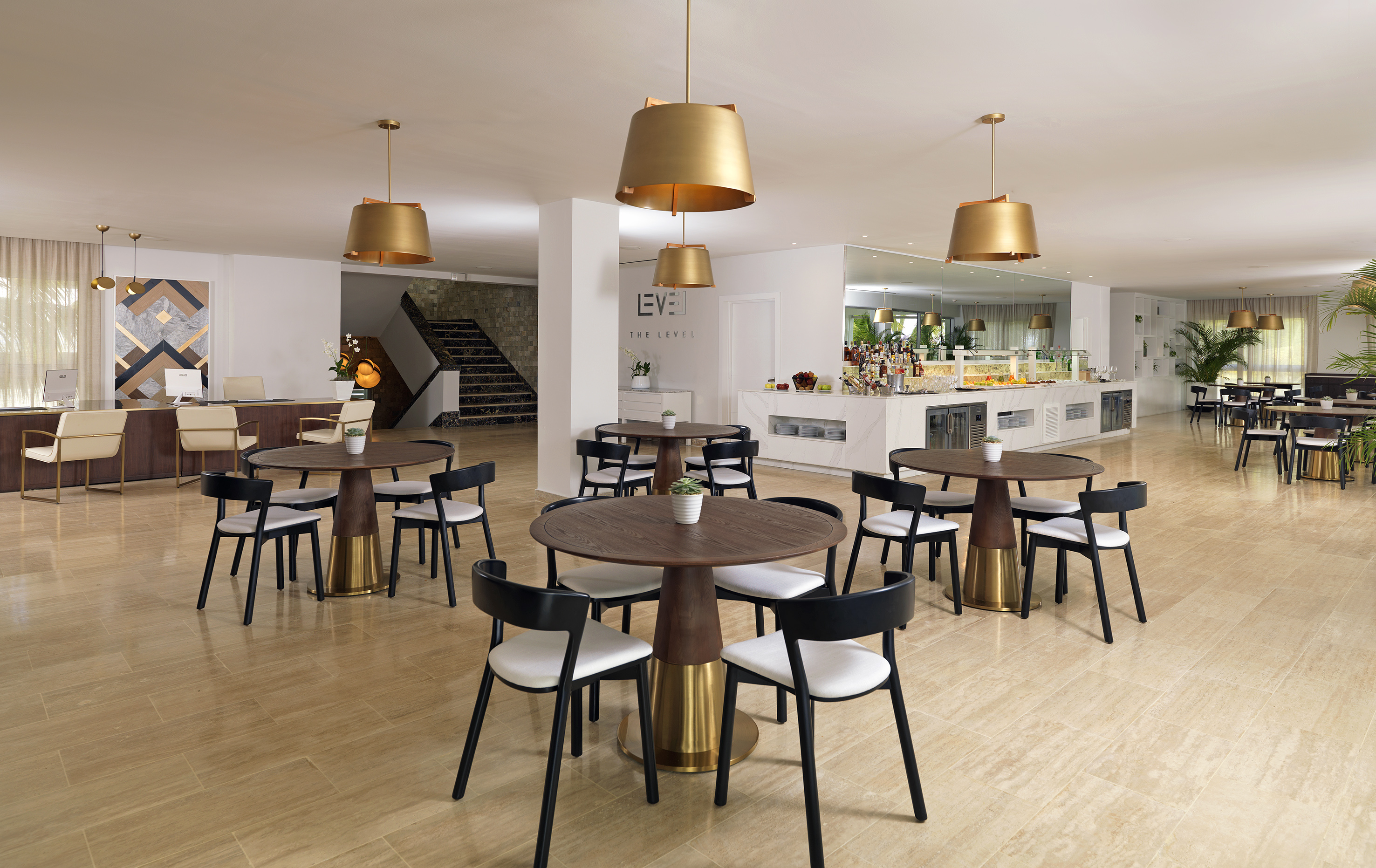 Modern hotel lounge with buffet, reception, dining tables & gold lighting.