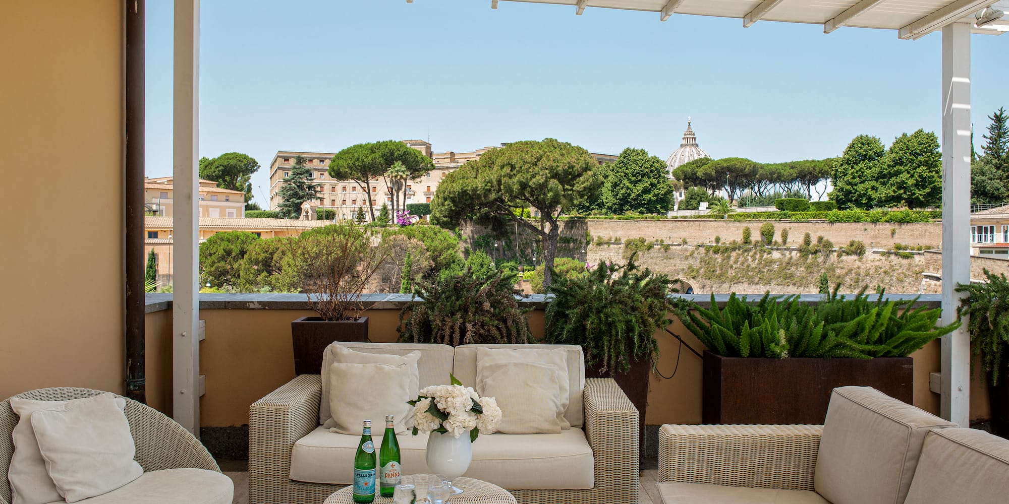 a patio with furniture and plants