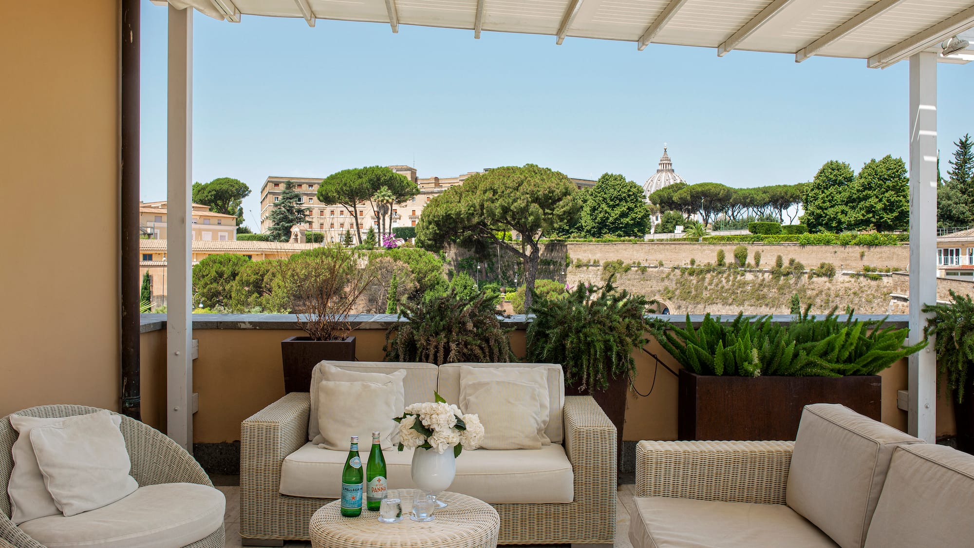 a patio with furniture and plants