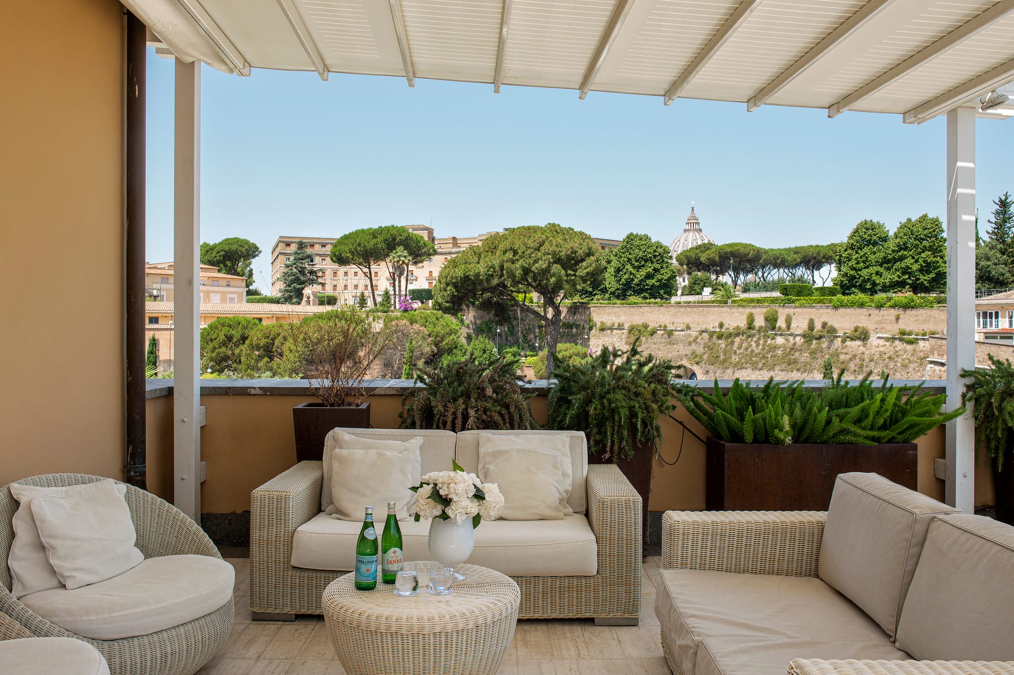 a patio with furniture and plants