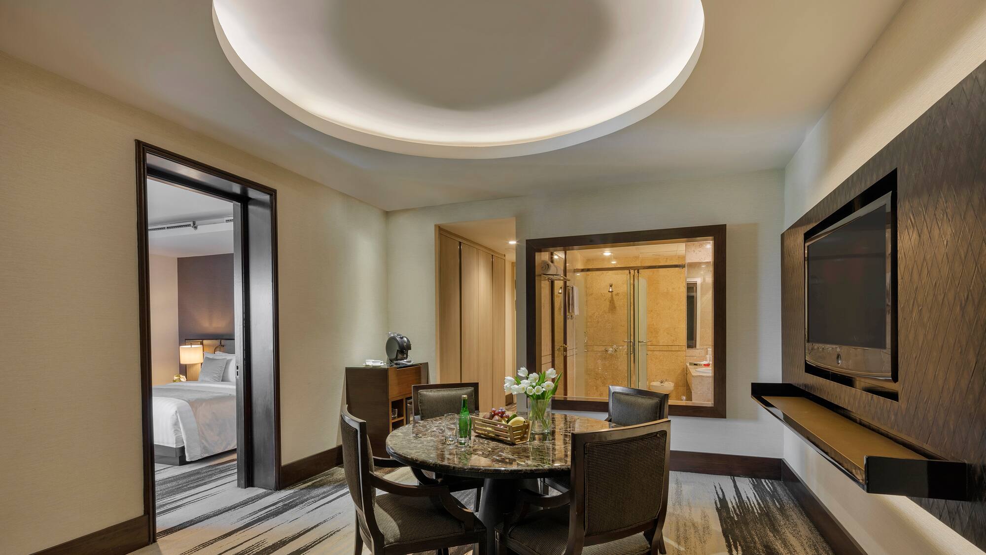 a room with a round table and chairs