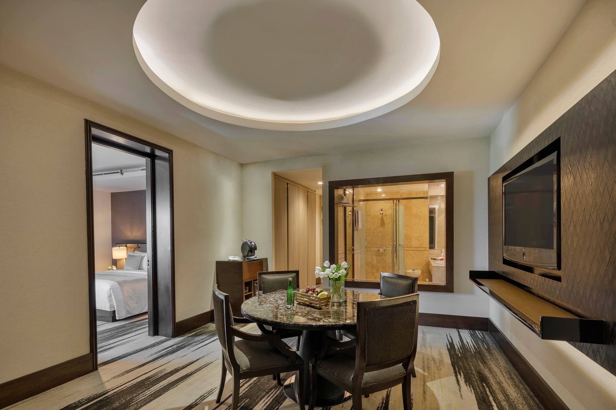 a room with a round table and chairs