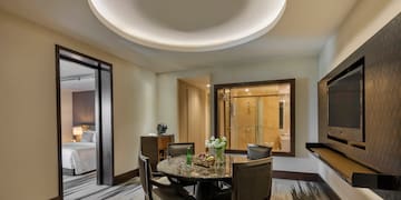 a room with a round table and chairs