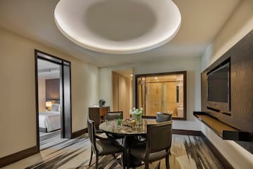a room with a round table and chairs