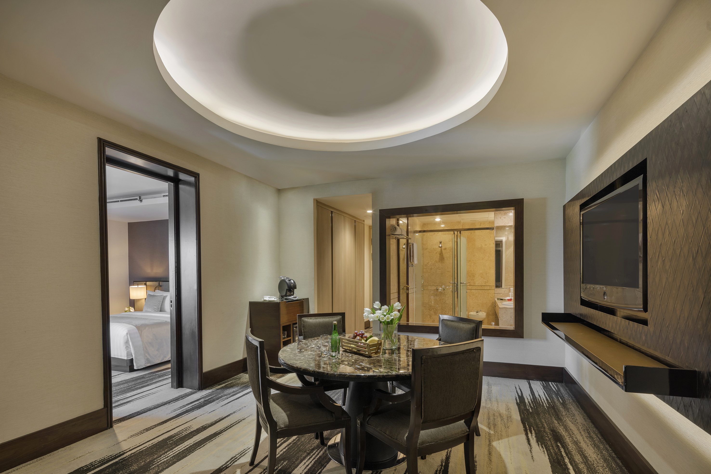 a room with a round table and chairs