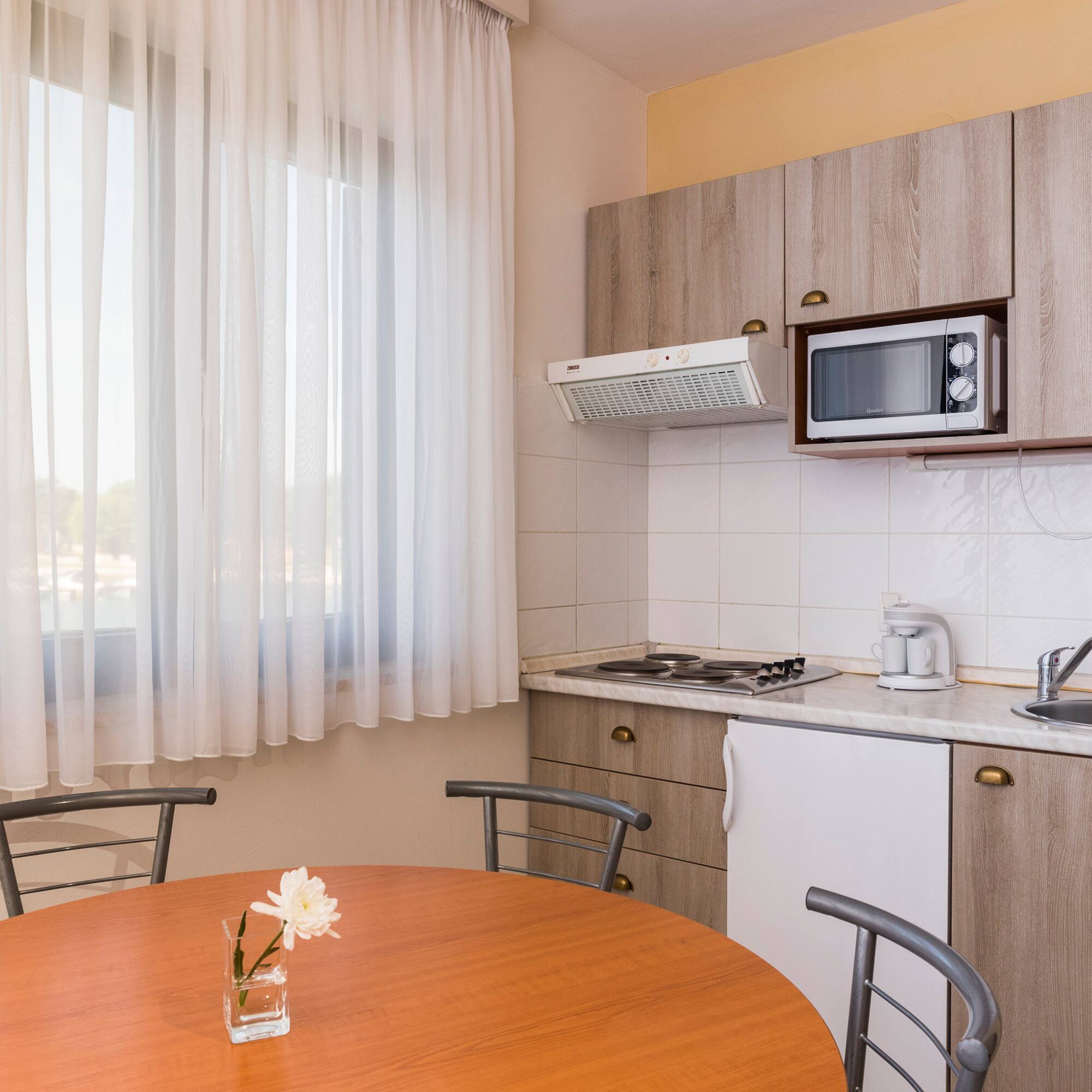 a kitchen with a table and chairs