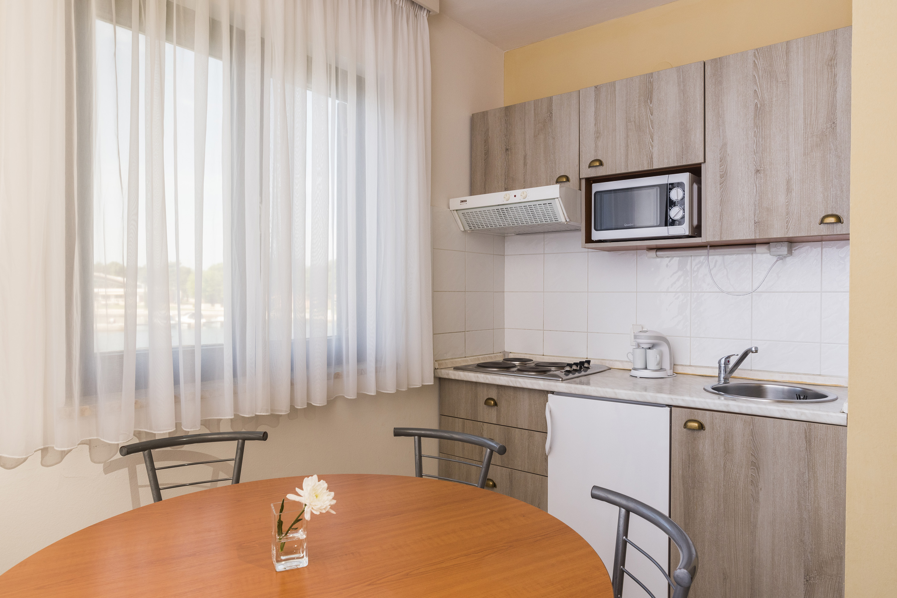 a kitchen with a table and chairs