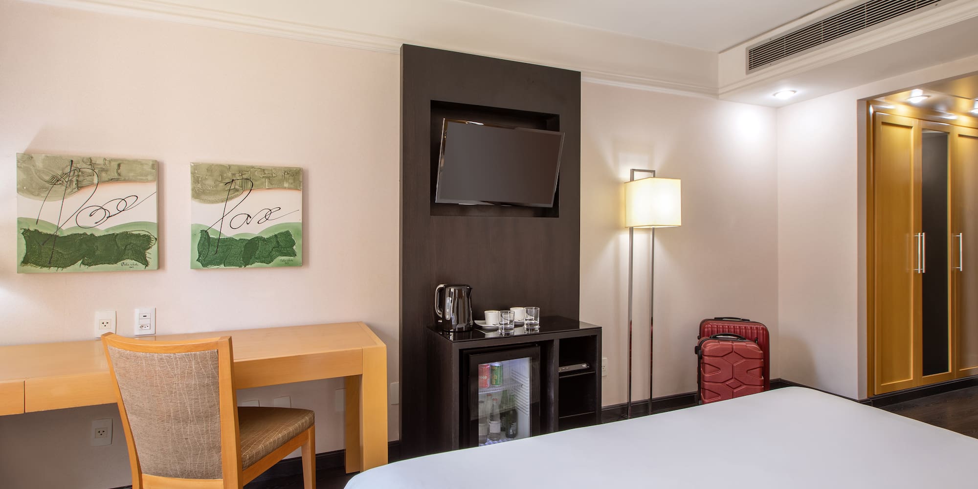 a room with a bed and a table and chair