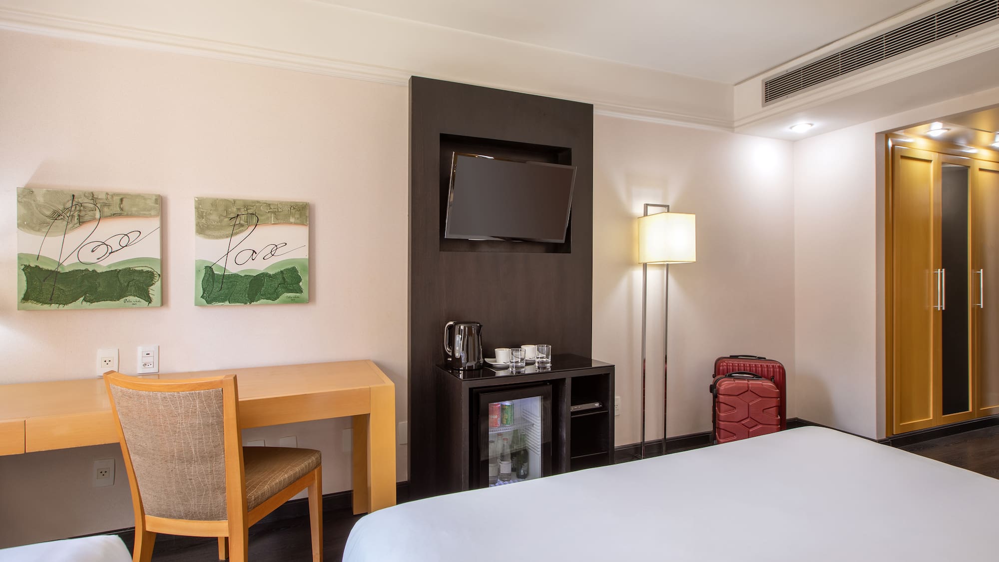 a room with a bed and a table and chair