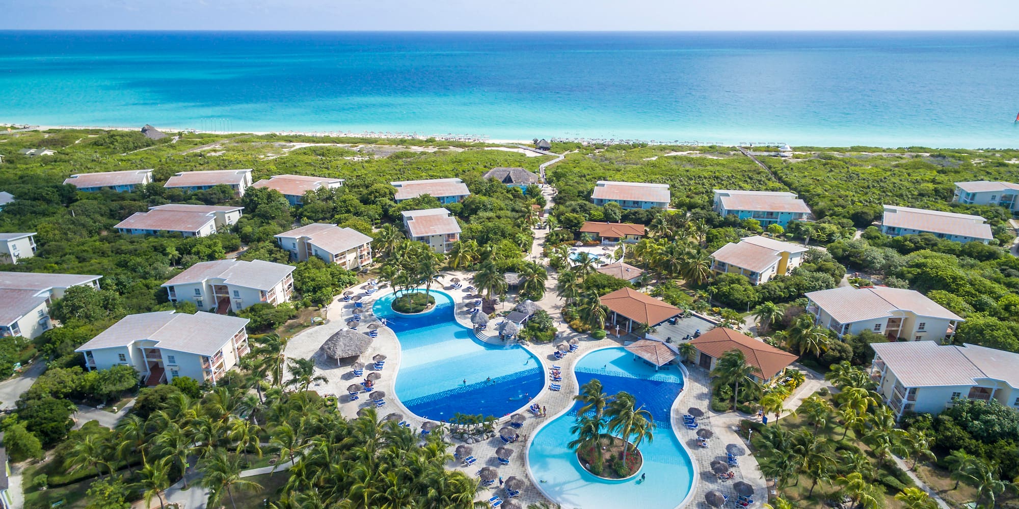 a swimming pool surrounded by trees and buildings