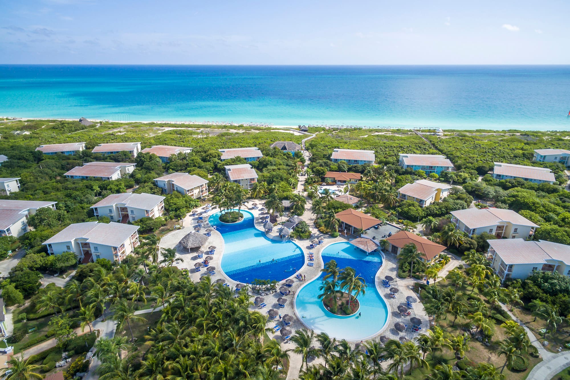 a swimming pool surrounded by trees and buildings