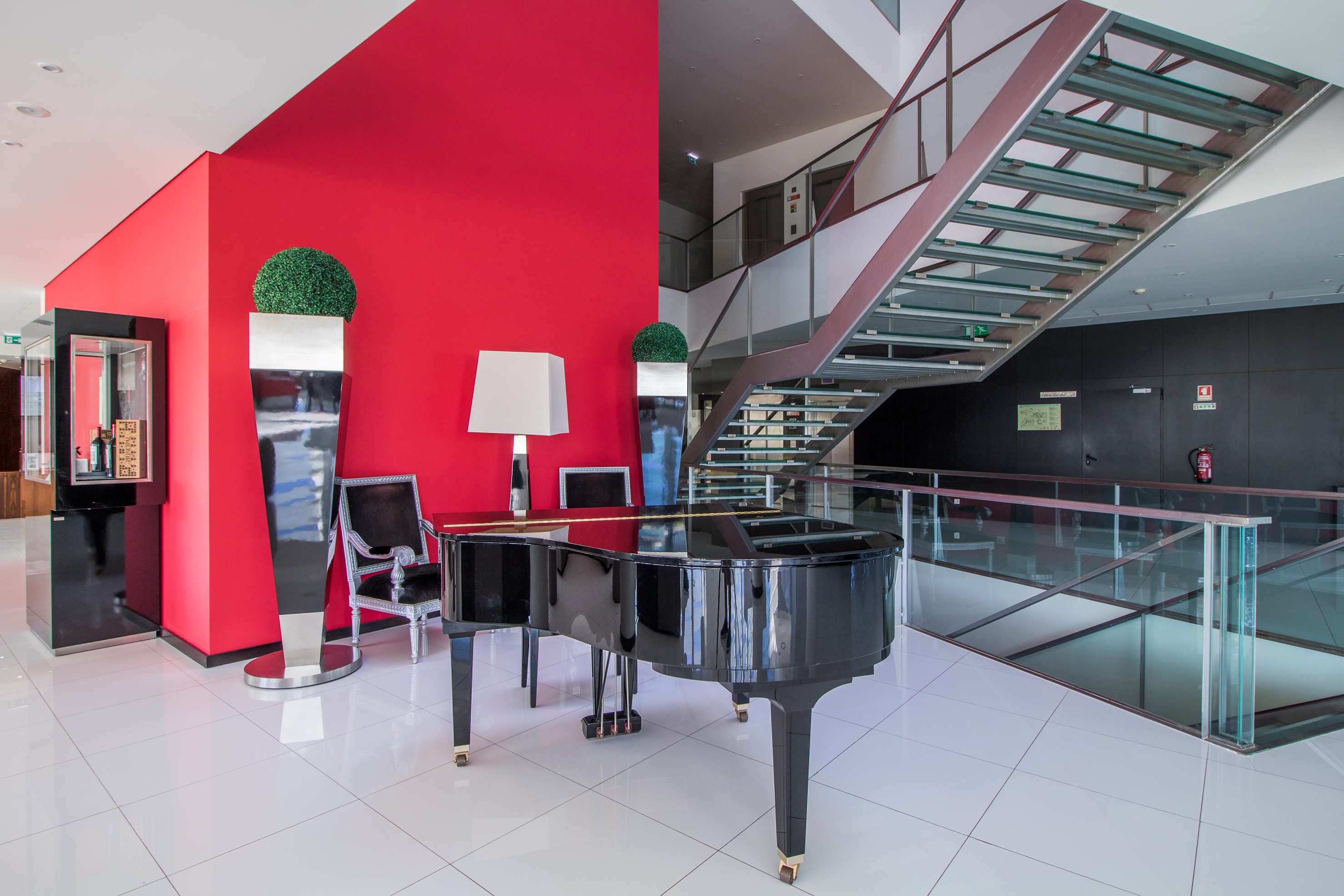 a piano in a room with a staircase
