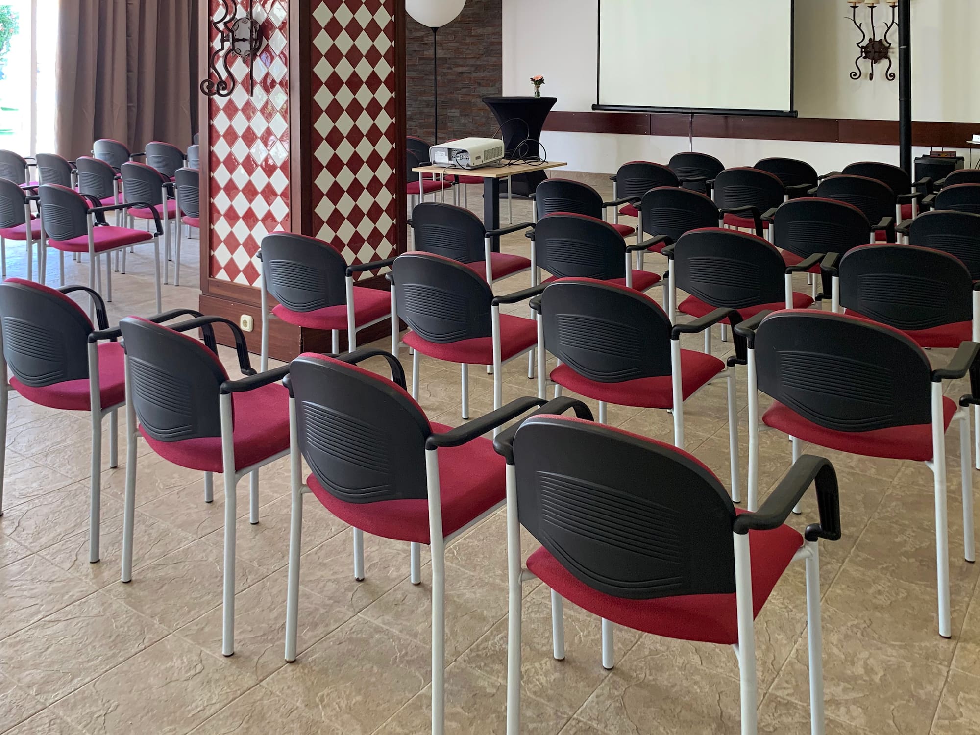 a room with chairs and a projector screen