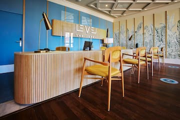 a reception desk with chairs and a lamp