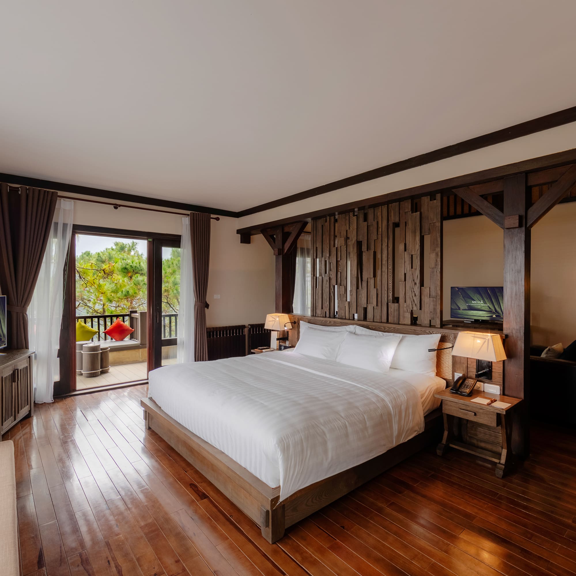 a bedroom with a wood floor and a large bed