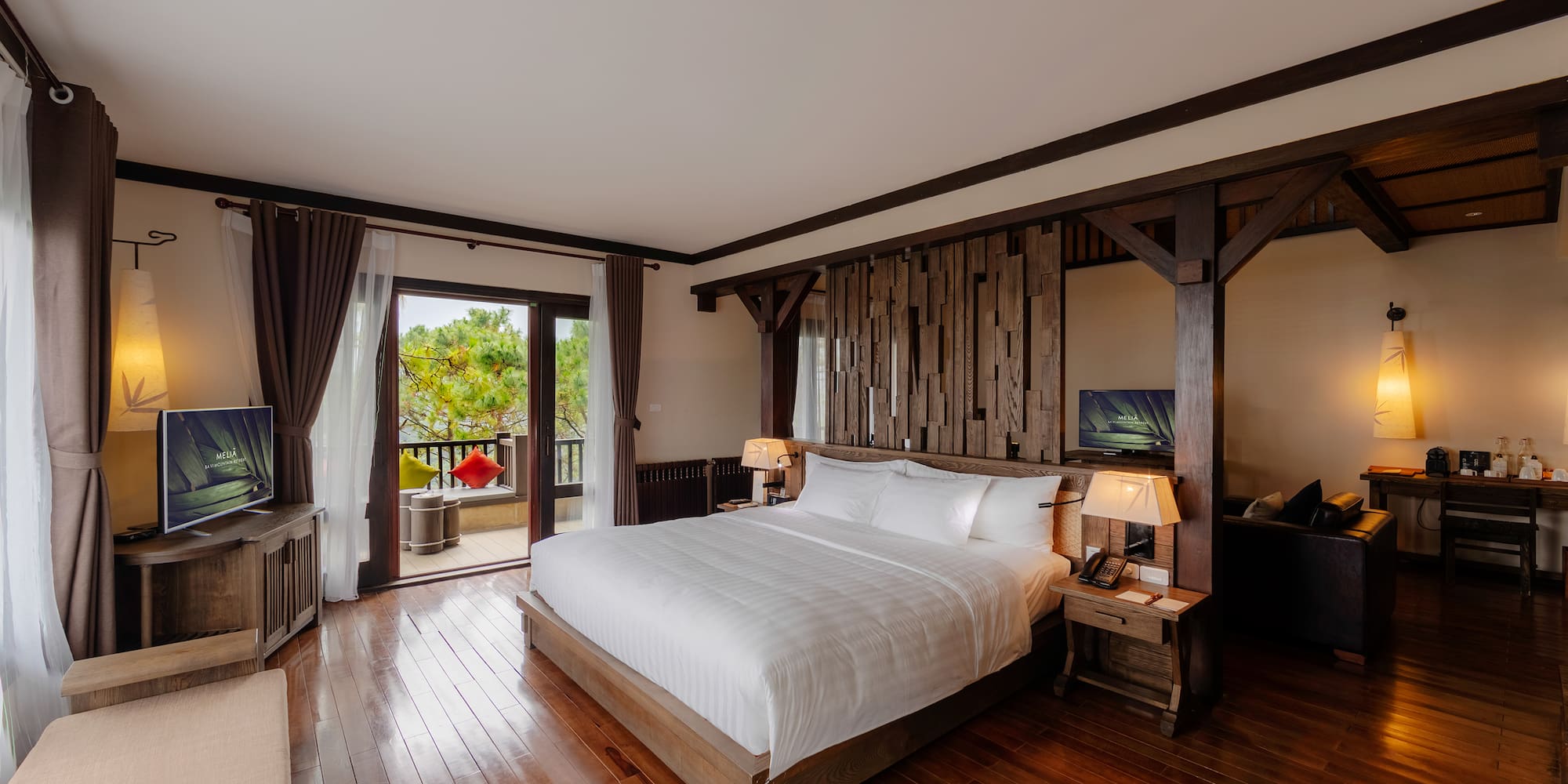 a bedroom with a wood floor and a large bed