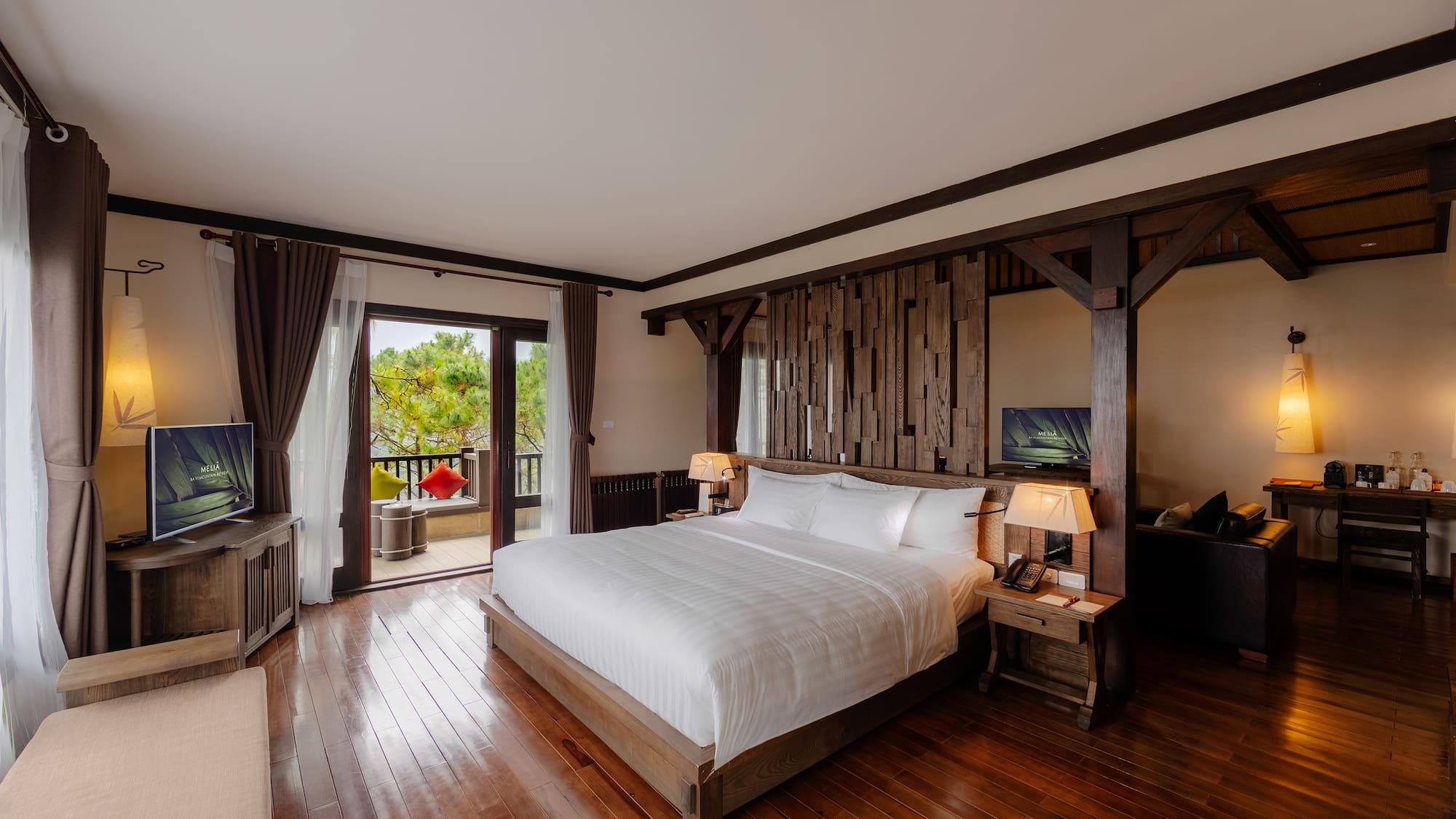 a bedroom with a wood floor and a large bed