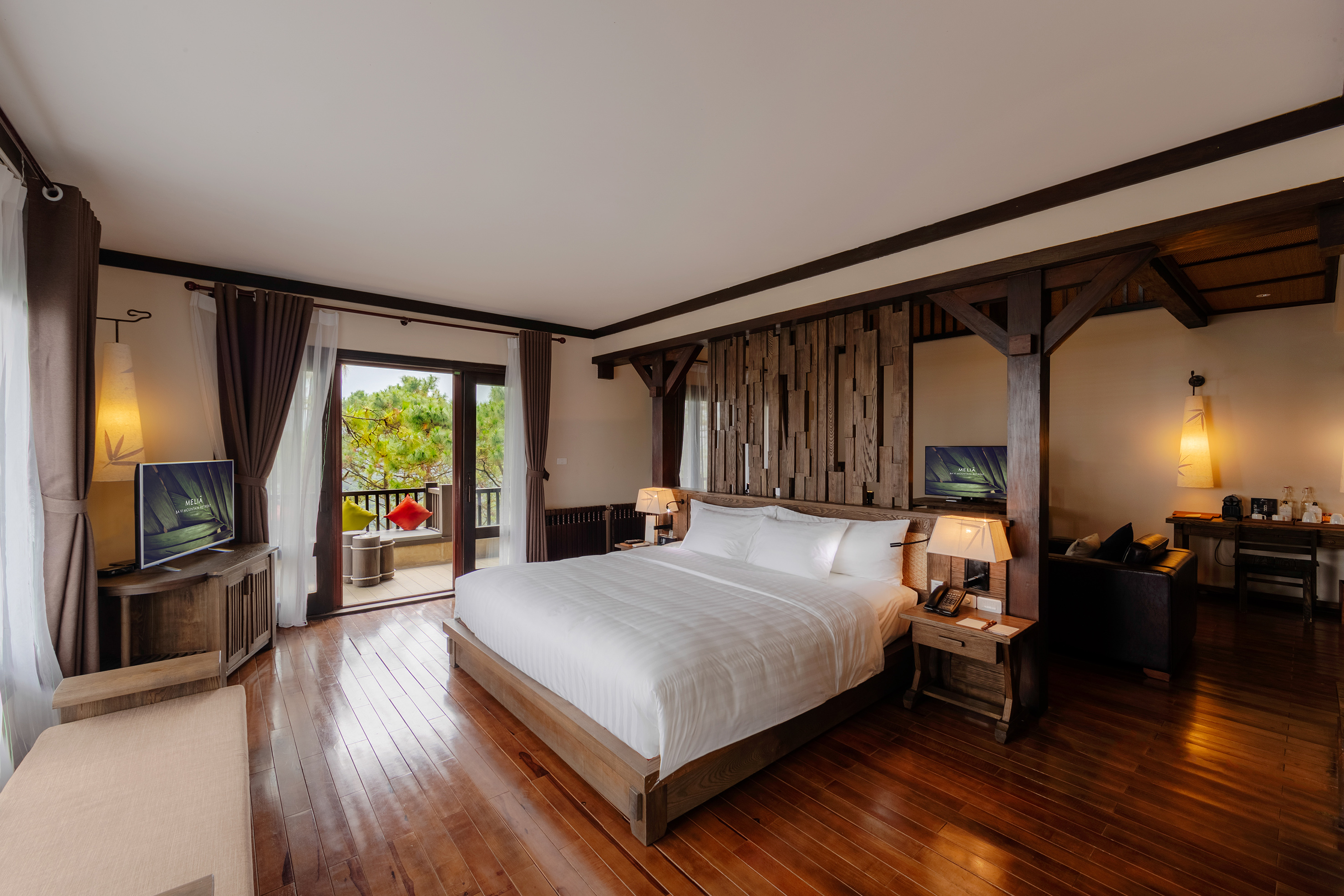 a bedroom with a wood floor and a large bed