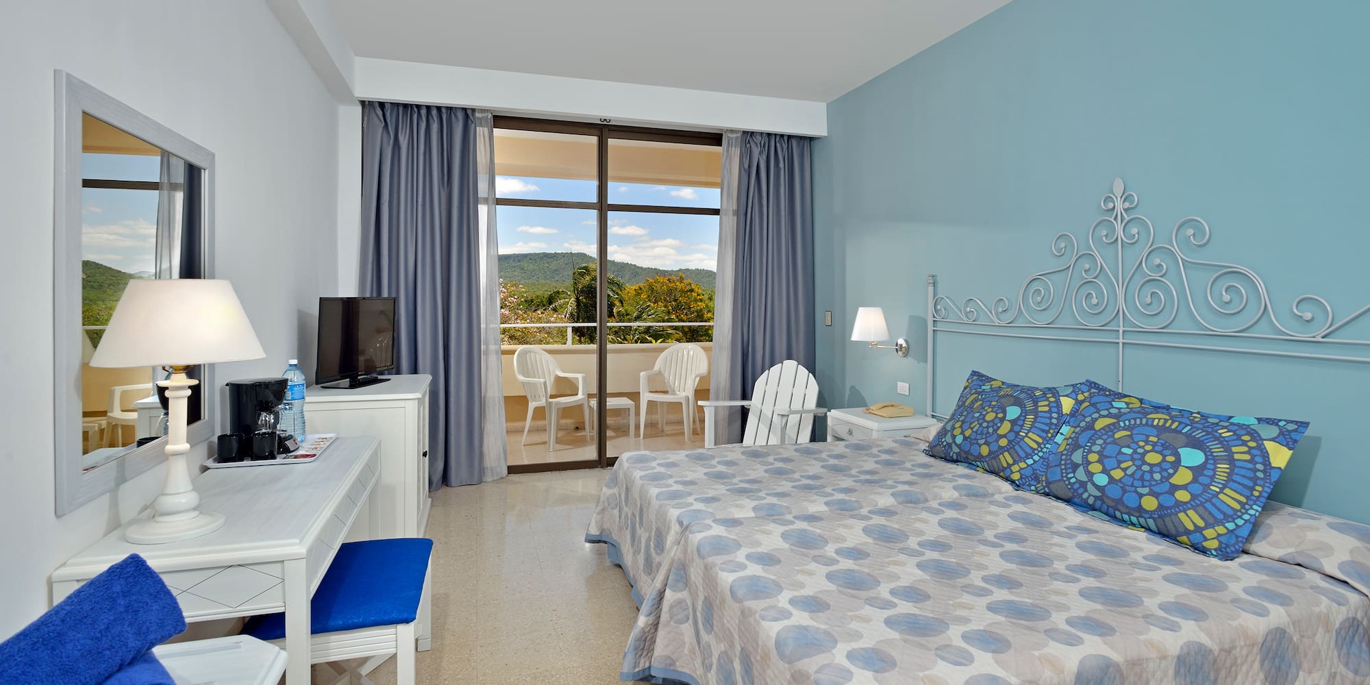 a room with a bed and a desk and chair