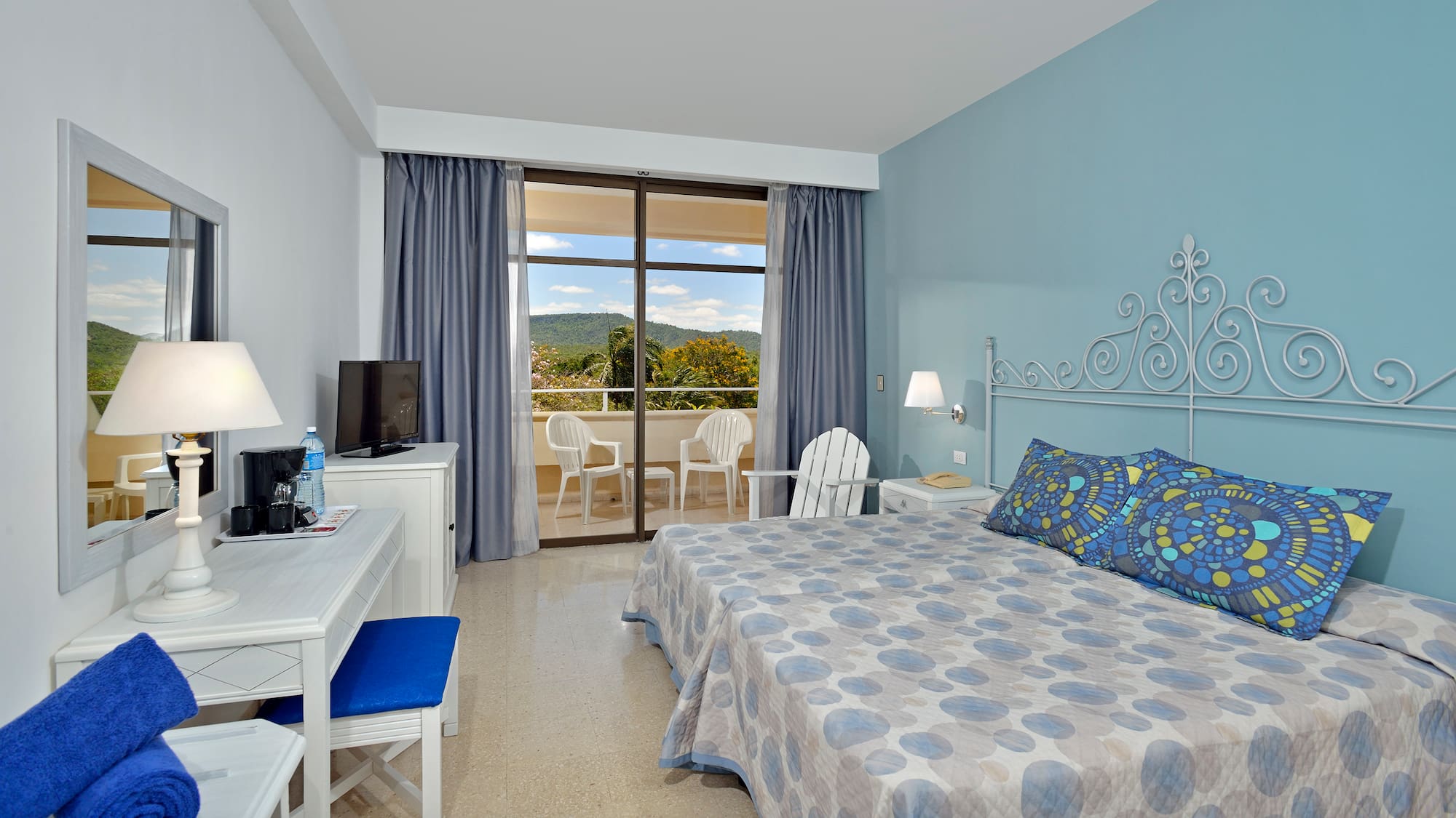 a room with a bed and a desk and chair