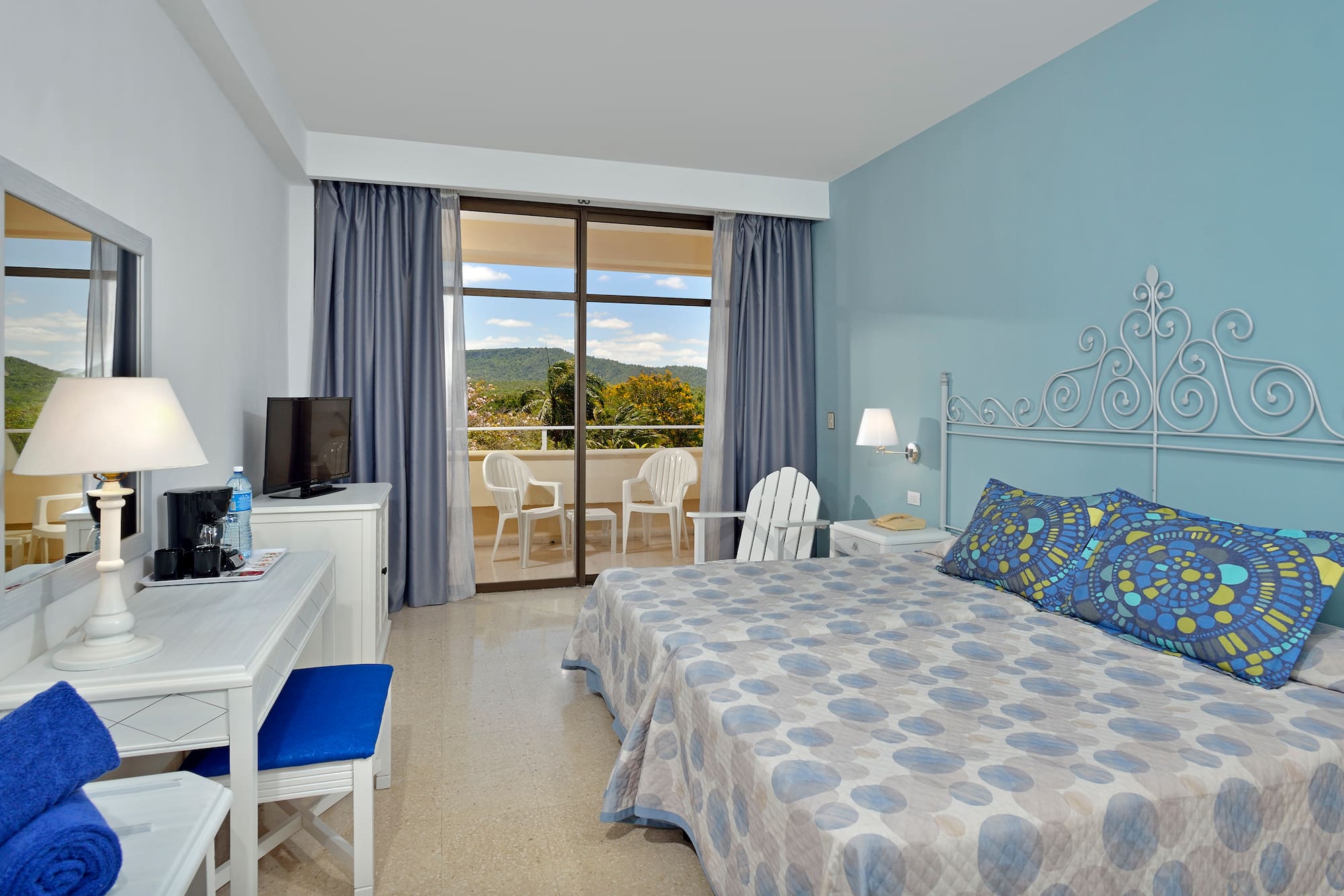 a room with a bed and a desk and chair