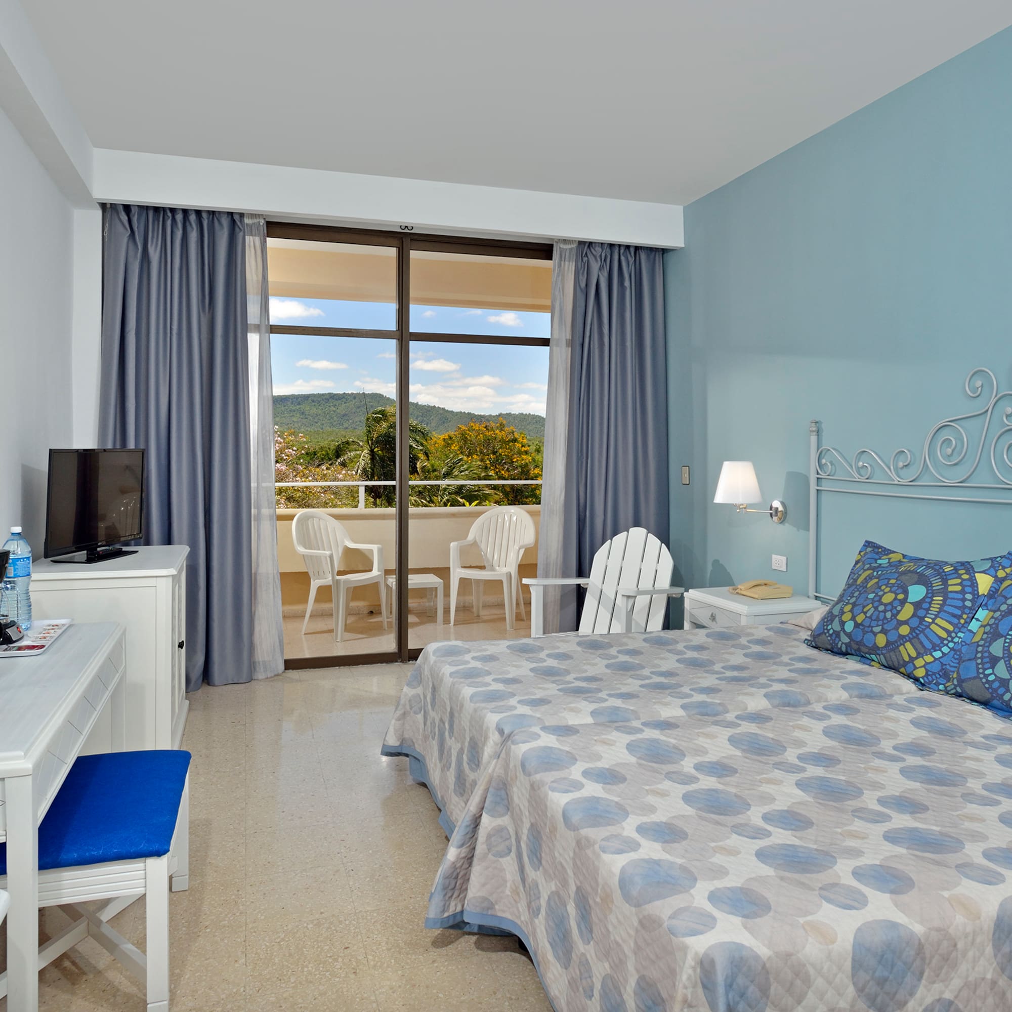 a room with a bed and a desk and chair