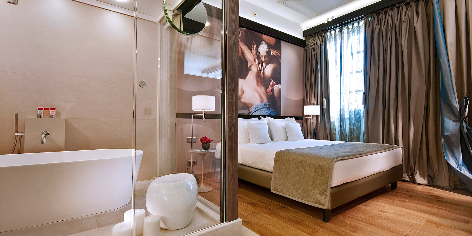 a bedroom with a glass shower and a bed
