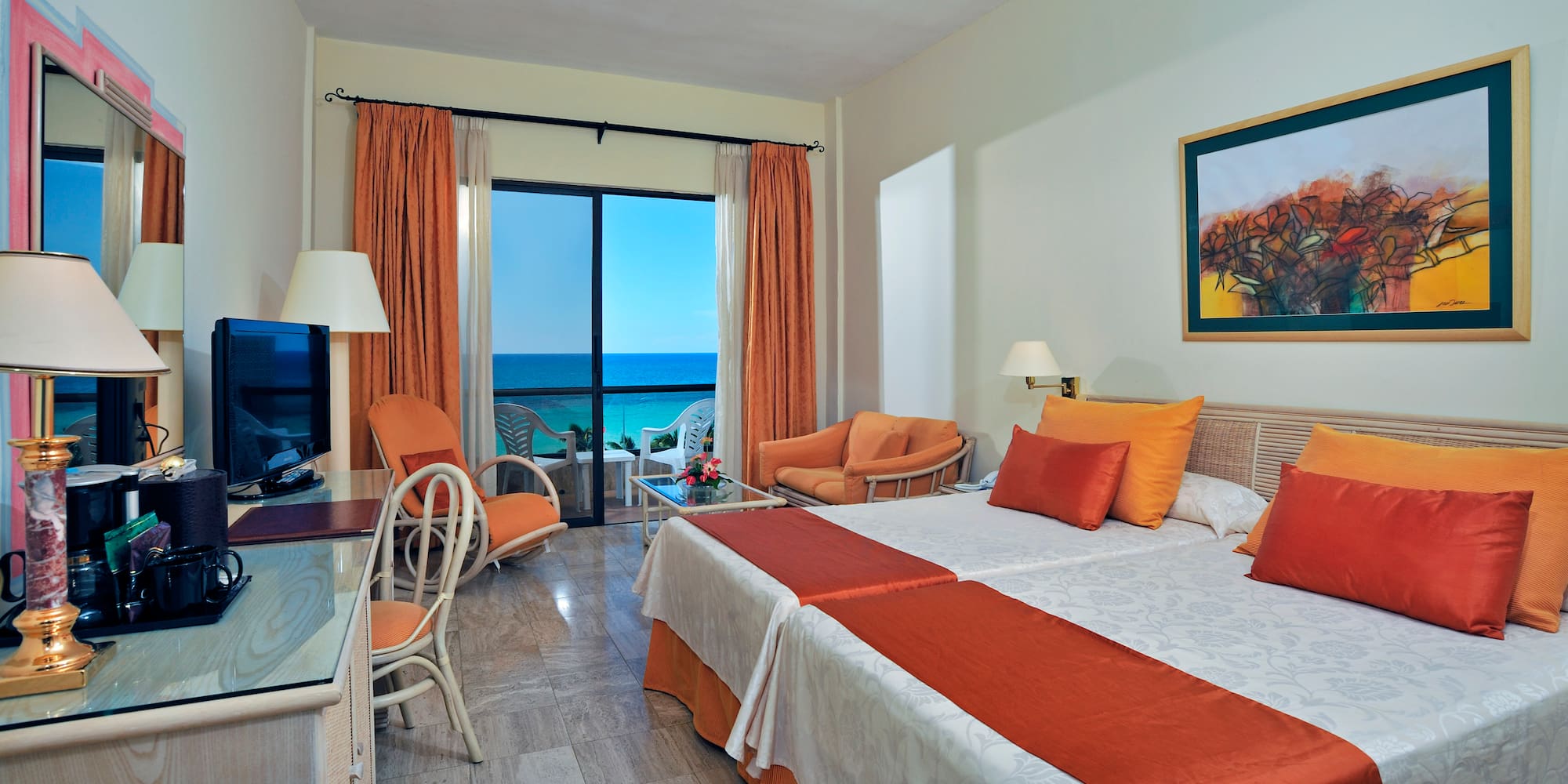 a room with two beds and a television