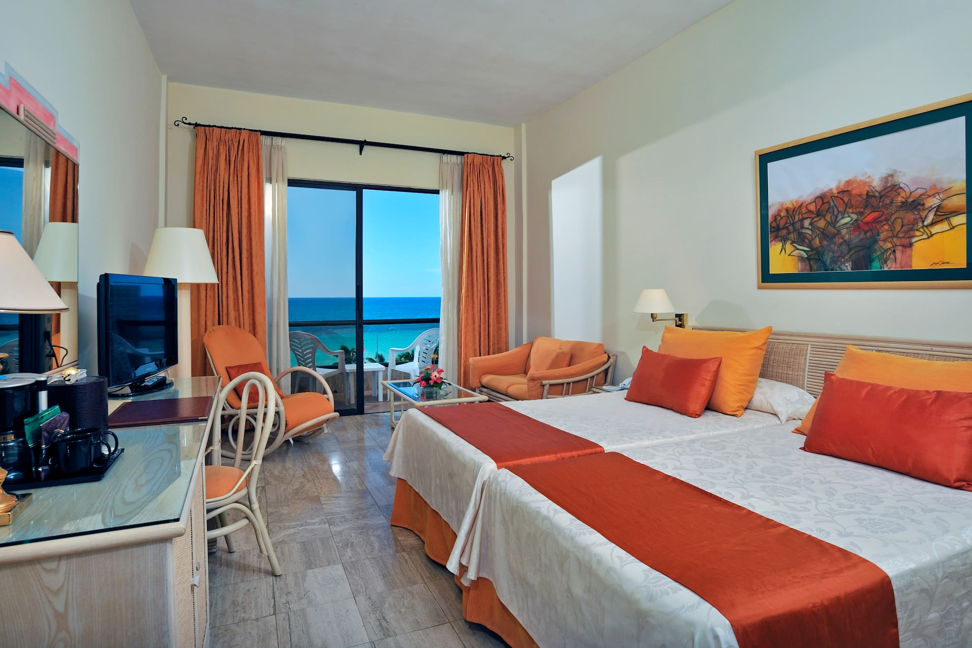 a room with two beds and a television