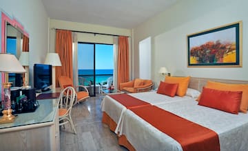 a room with two beds and a television