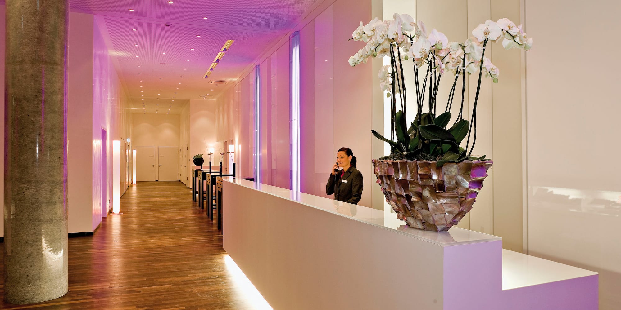 a woman standing in front of a reception desk