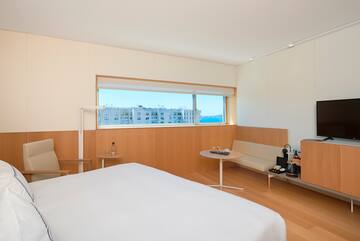 a room with a bed and a bench