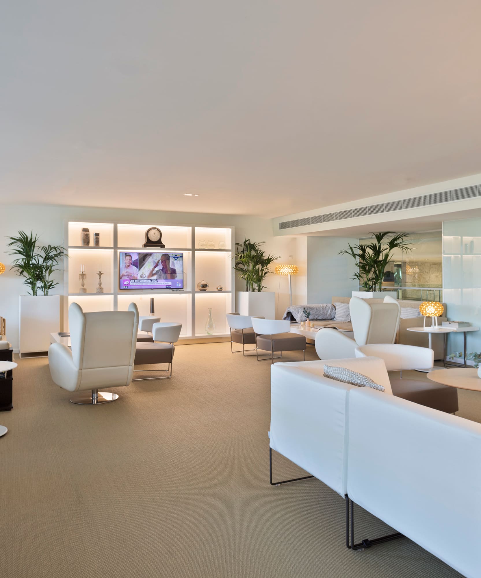 a room with white furniture and a tv