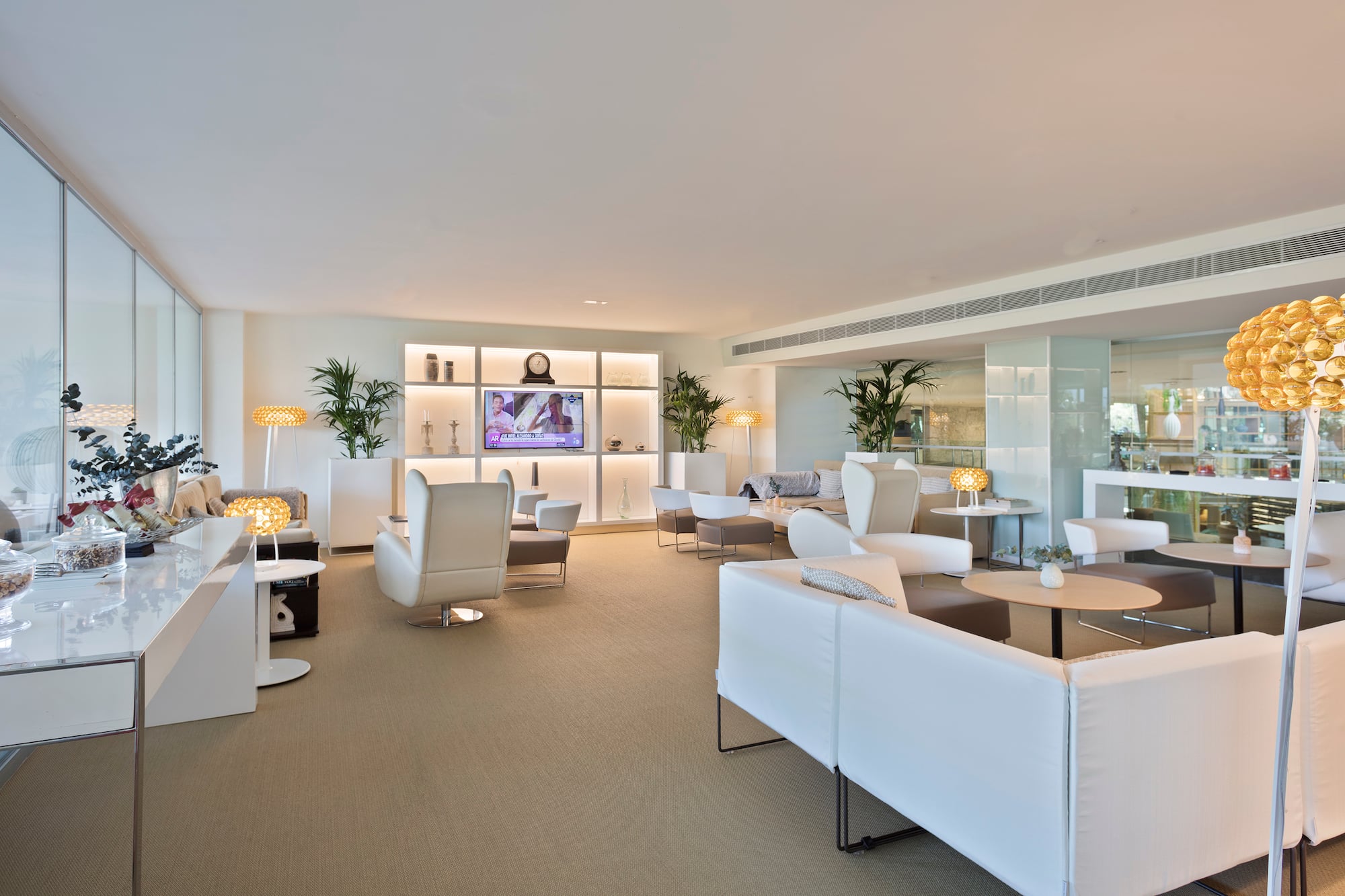 a room with white furniture and a tv