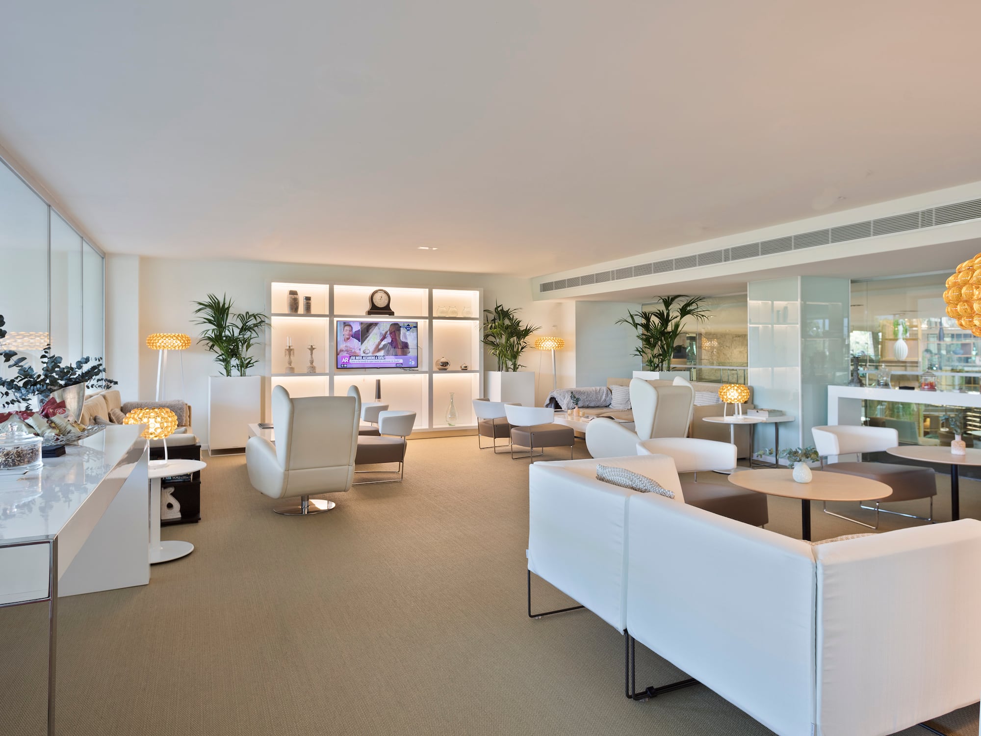 a room with white furniture and a tv