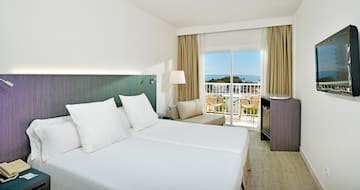 a room with two beds and a balcony