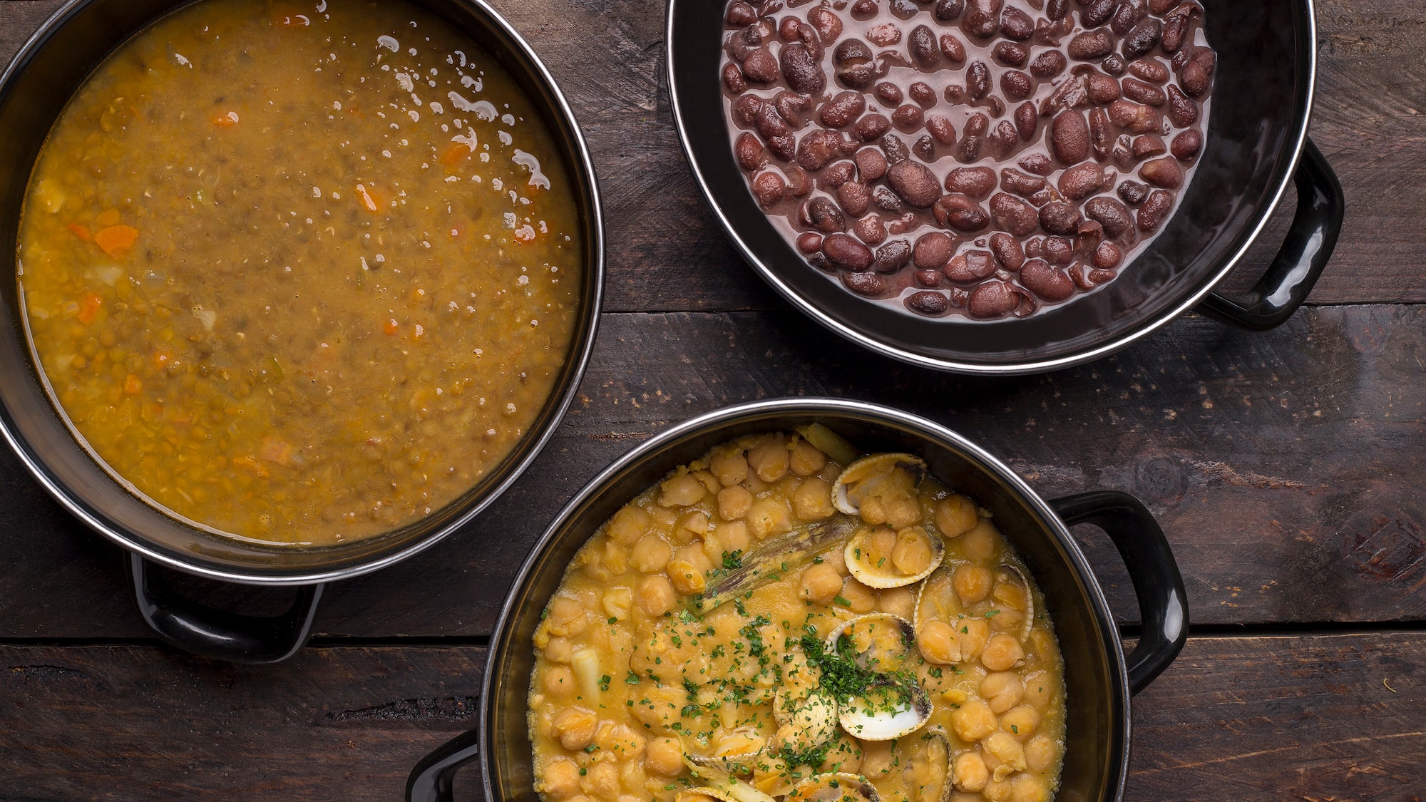 a group of bowls of soup and beans