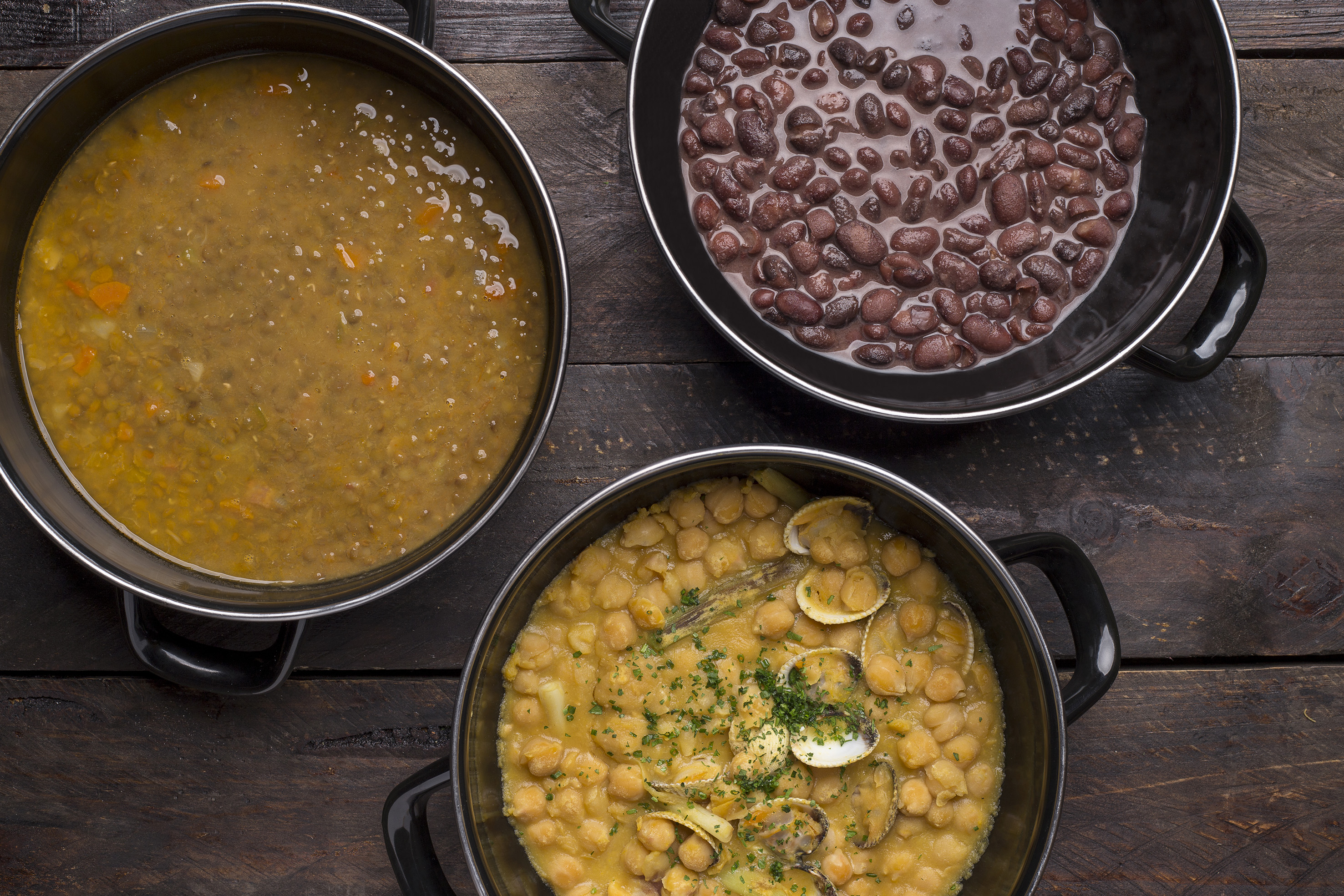 Three pots: lentil soup, black beans, and chickpea stew with clams.