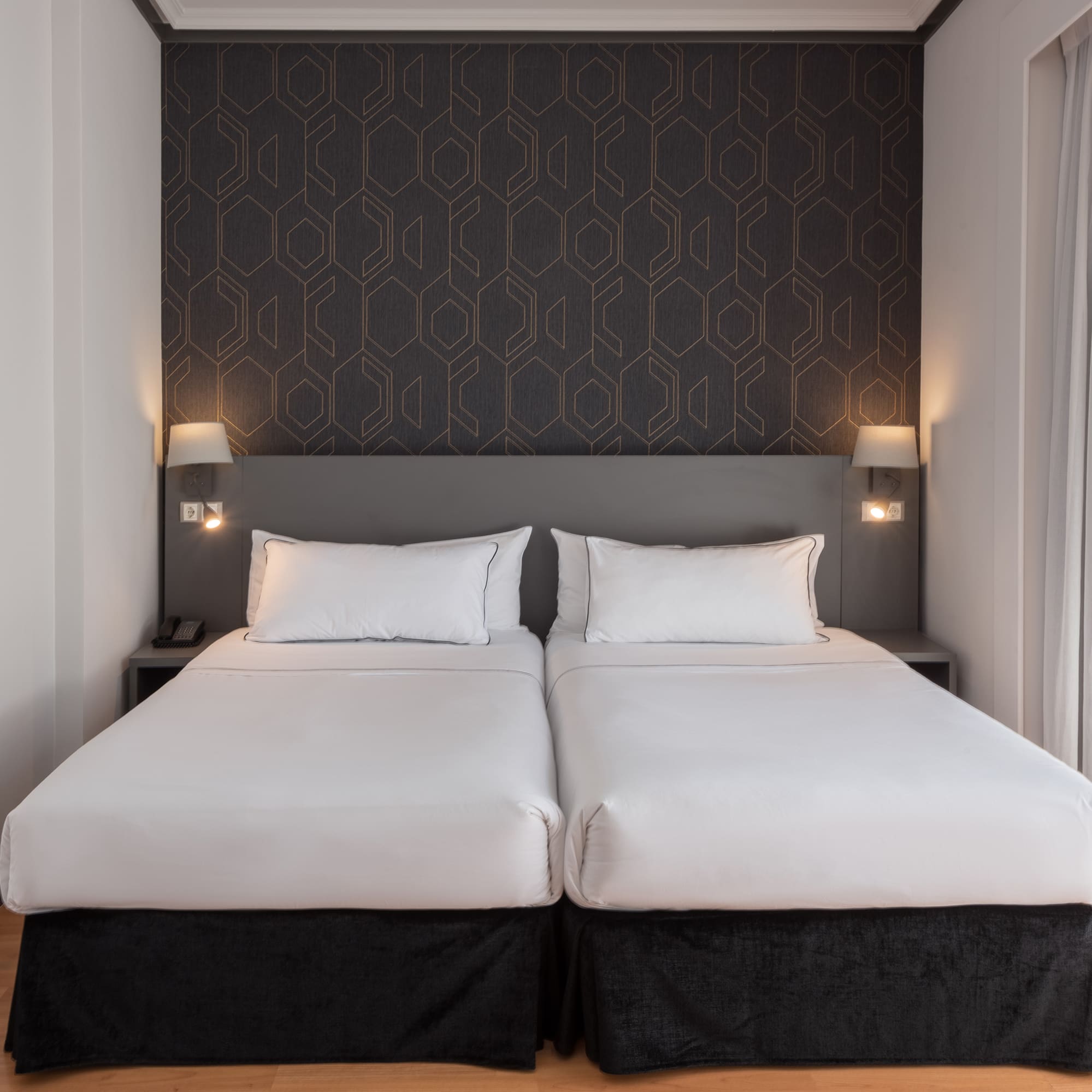 a bed with white sheets and pillows