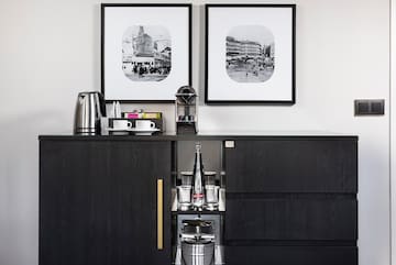 a black cabinet with a couple framed pictures on it