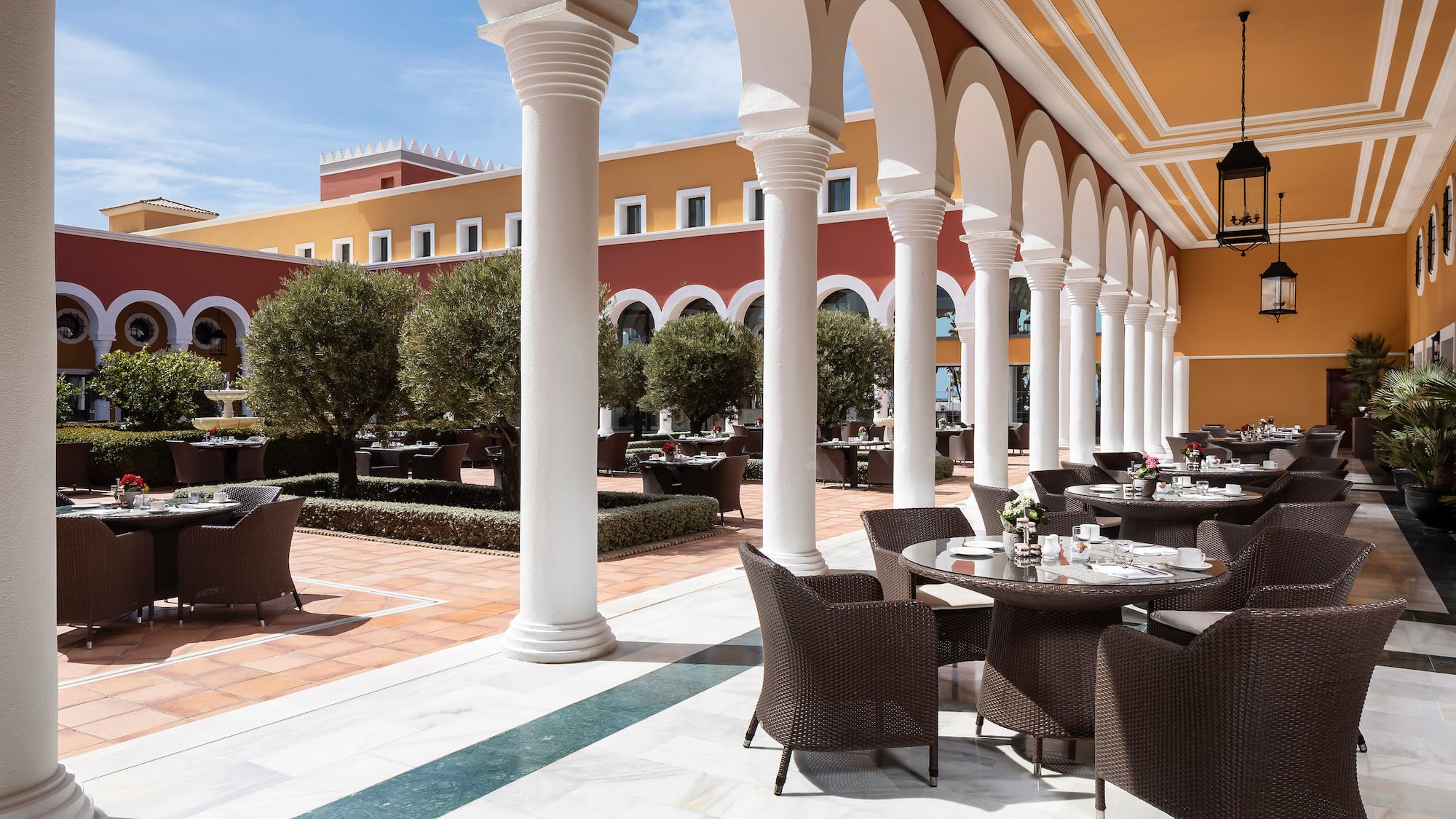 a patio with tables and chairs
