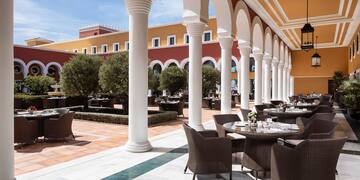 a patio with tables and chairs